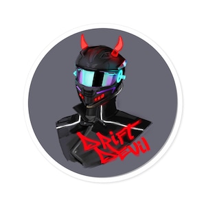 May include: A sticker depicting a black helmet with red horns and a visor, with the text "DRIFT DEVIL" in red. The helmet has neon accents, set against a grey background within a white circle. The design is a digital illustration.