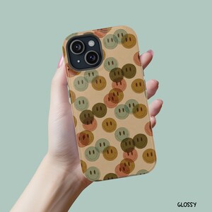 May include: A phone case with a neutral vibe. The case is glossy and has a cutout for the camera lens.