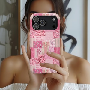 May include: Pink patchwork phone case with the text "Cowboys and Jesus". The case features a variety of pink patterns, including zebra print, floral designs, and cow print. The phone case is held in front of a person.