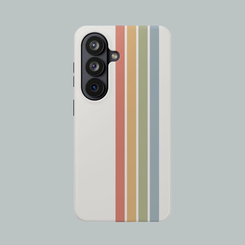 May include: A white phone case with a vertical striped design in muted colors: red, yellow, green, and blue. The phone case has a camera module with three lenses on the left side.