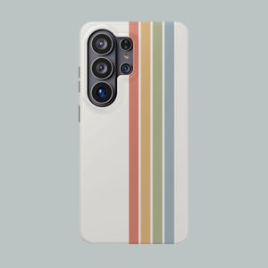 May include: A white phone case with a vertical stripe design in pastel colors: red, yellow, green, and blue. The case has a camera module on the upper left side.