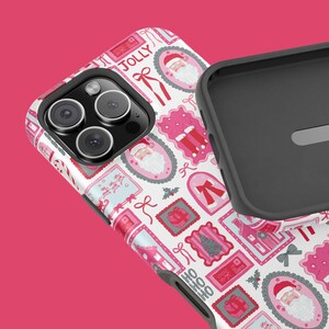 May include: A white and pink phone case with a festive Christmas pattern. The design includes Santa Claus, gift boxes, bows, and the word "JOLLY". The case is shown next to a black phone case.