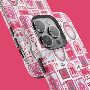 May include: A white iPhone case with a repeating pattern of pink and light blue Christmas-themed illustrations. The design includes images of Santa Claus, candy canes, bows, and houses. The word "JOLLY" is visible in the design.
