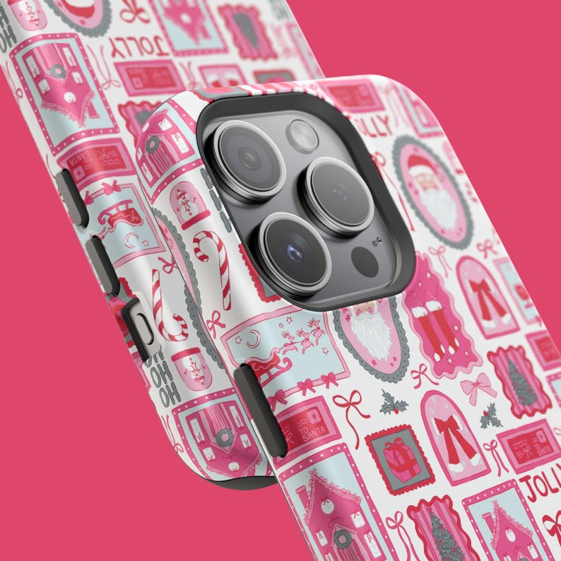 May include: A white iPhone case with a repeating pattern of pink and light blue Christmas-themed illustrations. The design includes images of Santa Claus, candy canes, bows, and houses. The word "JOLLY" is visible in the design.