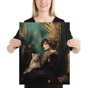 May include: A woman in a black lace dress and a floral headband sits with a leopard in a lush, green jungle setting. The woman's makeup is dramatic, with dark eyes and red lips. The leopard is lying on the woman's lap, looking at the camera.
