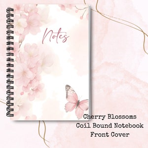May include: A pink and white coil bound notebook featuring a watercolour design of cherry blossoms and a butterfly. The front cover has the word "Notes" written in cursive.