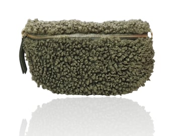 May include: A green fuzzy fabric fanny pack with a gold zipper.
