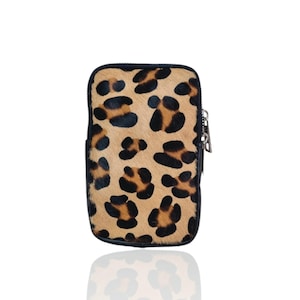 May include: A small black and brown leopard print phone case with a zipper closure.