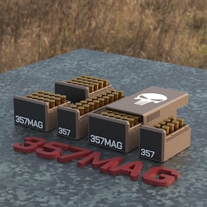 May include: Four boxes of .357 MAG ammunition with a skull graphic on the top box. The boxes are stacked on a camouflage surface.