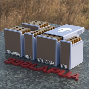 May include: A display of ammunition boxes, each filled with brass-colored bullets. The boxes are brown and white, with the text "338LAPUA" and "338" printed on them. One box has a skull graphic. A red 3D text of "338LAPUA" is in front of the boxes.