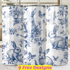 May include: White tumbler featuring a blue floral and rabbit design. The design includes rabbits, butterflies, and flowers. The text "9 Free Designs" is at the bottom of the image.
