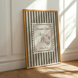 May include: A framed print with a vintage design, displaying the text "Pumpkin Patch" and "Farm Fresh". The artwork features a black and white illustration of two pumpkins, set against a striped background.