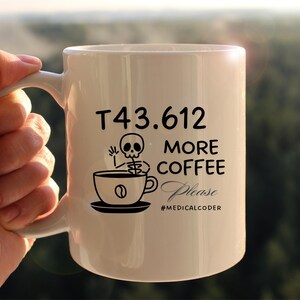 May include: White ceramic coffee mug with a black skeleton holding a coffee cup and the text "T43.612 More Coffee Please #MEDICALCODER".