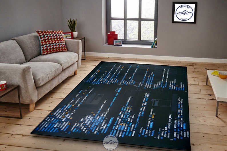 May include: A black and blue rug with code printed on it. The rug is laid out on a wooden floor in a living room setting with a couch and a coffee table.