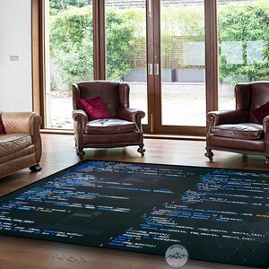 May include: A black and blue rug with code printed on it. The rug is in a living room with two brown leather armchairs and a brown leather sofa. The rug has a logo in the bottom right corner that says "Erciyes Carpet".