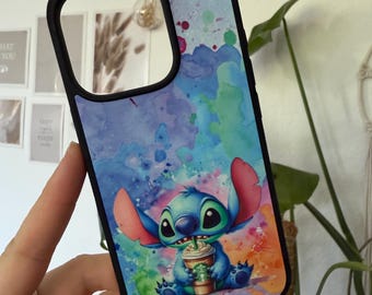 May include: Black phone case featuring a watercolor design with Stitch, the blue alien from Lilo & Stitch, holding a coffee cup. The case has a black border and a colorful background with blue, purple, and green hues.