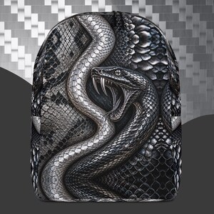May include: A backpack featuring a detailed graphic print of a coiled snake with its mouth open, revealing sharp fangs. The design showcases a monochromatic color palette of black, white, and gray, with a realistic scale texture covering the entire surface.