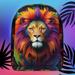 May include: A colorful backpack with a vibrant lion's face design. The lion's mane is a mix of orange, red, purple, and blue hues. The background is a dark blue with a subtle sparkle effect.