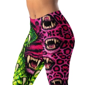 May include: Leggings with a striking design. The leggings display a repeating pattern of open mouths with sharp teeth in shades of pink and green. The design has a leopard print background.