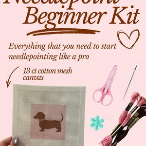 May include: Needlepoint Beginner Kit with a dachshund design on a 13 ct cotton mesh canvas. Includes pink scissors, embroidery floss, a needle, and a flower-shaped bead. The kit is designed for beginners and includes a carrier zipper pouch.