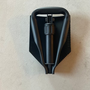 Military E tool / shovel , considered used with scratches . Including a free Entrenching tool pouch , Abu color.