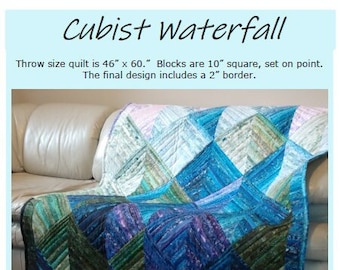May include: A throw-size quilt with a cubist waterfall design, measuring 46 x 60 inches. The quilt features a geometric pattern in shades of blue, green, and purple, with a 2-inch border. The blocks are 10 inches square and set on point.