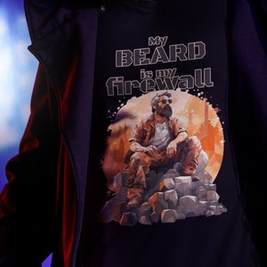 Peut inclure: Un t-shirt noir avec un graphique d'un homme barbu assis sur un tas de rochers. Le texte "My Beard is my Firewall" est imprimé sur le t-shirt.