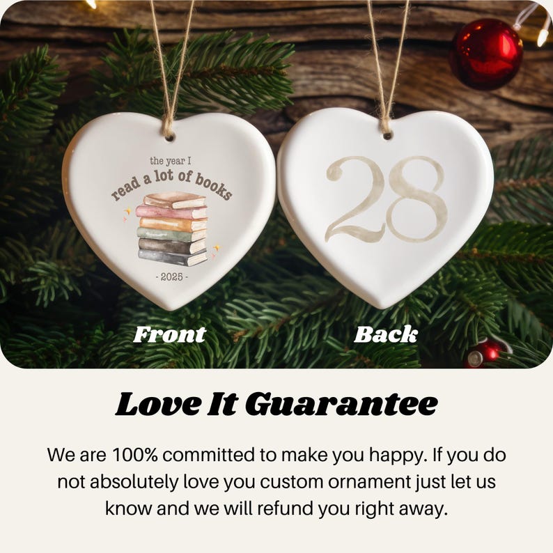 May include: Two heart-shaped ceramic ornaments. One features a stack of books with the text "read a lot of books" and "-2025-". The other has the number "28". Both are white with a string for hanging.