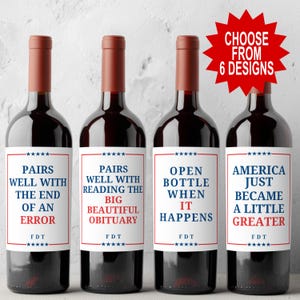May include: Four bottles of red wine with humorous labels. The labels feature phrases like "Pairs well with the end of an error" and "America just became a little greater." A red starburst graphic says "Choose from 6 designs."