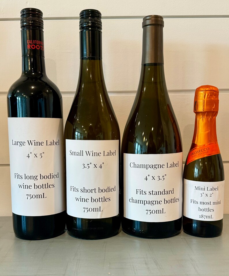 Four wine bottles with labels showing different sizes and dimensions. The labels read 'Large Wine Label 4' x 5' Fits long bodied wine bottles 750mL', 'Small Wine Label 3.5' x 4' Fits short bodied wine bottles 750mL', 'Champagne Label 4' x 3.5' Fits standard champagne bottles 750mL', and 'Mini Label 3' x 2' Fits most mini bottles 187mL’.