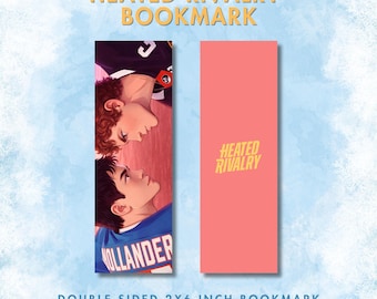 May include: Double-sided bookmark featuring two men in sports jerseys, with the text "Heated Rivalry" at the top. The reverse side is coral with the title in yellow. The bookmark is 2 x 6 inches.