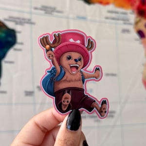 May include: A cartoon sticker of a brown and pink character with antlers, wearing a pink hat and a blue backpack. The character is jumping and has a big smile.