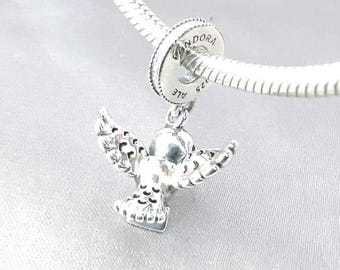 May include: A silver charm shaped like a bird with wings spread wide, suspended from a silver snake chain bracelet. The charm features engraved detailing on the wings and tail, and the circular bead connector is stamped with the text PANDORA S925 ALE.