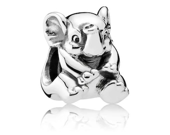 May include: A silver charm in the shape of a sitting elephant. The elephant has a detailed, realistic design with a textured surface.