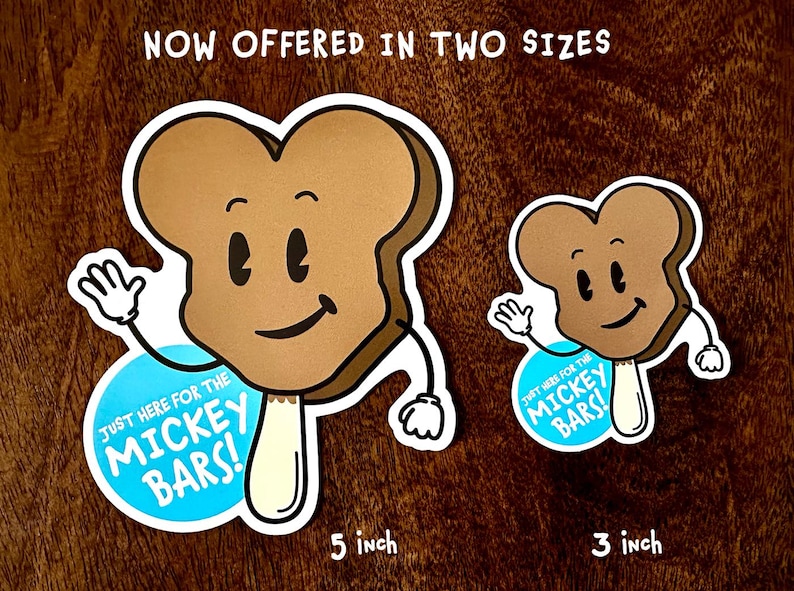 May include: Two brown and white Mickey Bar stickers with a cartoon face and arms. The larger sticker is 5 inches and the smaller sticker is 3 inches. Both stickers have a blue circle with the text "Just here for the Mickey Bars!"