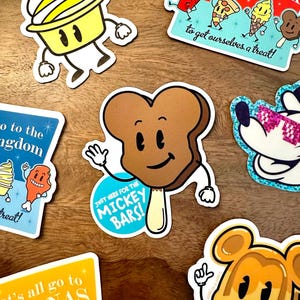 May include: A set of colorful stickers featuring cartoon characters of various foods and drinks. The stickers have a retro style and include phrases like "Let's all go to the Snack Deck" and "Just here for the Mickey Bars!"