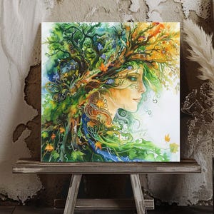 May include: A square watercolor painting of a woman's profile with flowing hair made of leaves and branches. The artwork features vibrant greens, blues, and yellows, with a white background. The painting is displayed on a small wooden table.
