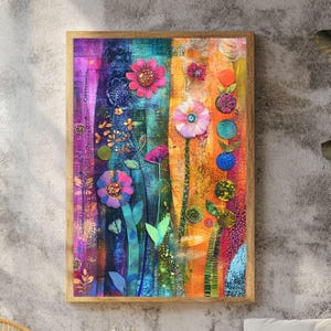 May include: A framed floral art print with a vibrant, colorful design. The artwork features stylized flowers in shades of pink, purple, blue, and orange. The background has vertical stripes of color, and the frame is a light brown.