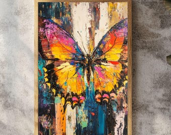 May include: A rectangular wall art piece featuring an abstract painting of a butterfly with vibrant yellow, orange, pink, and black colors. The butterfly is centered against a textured, multi-colored background with visible brushstrokes.