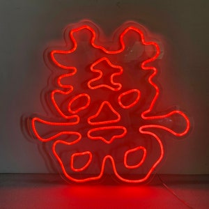 May include: Red neon sign featuring the Chinese character for "double happiness" in a stylised font.