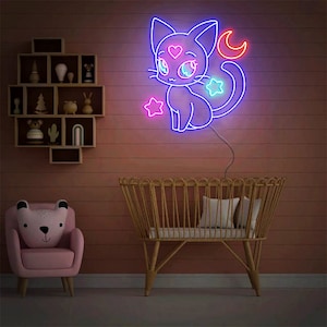May include: A neon sign depicting a cartoon cat with a crescent moon and stars. The cat is pink and blue with a pink heart on its chest. The sign is mounted on a wall above a crib.