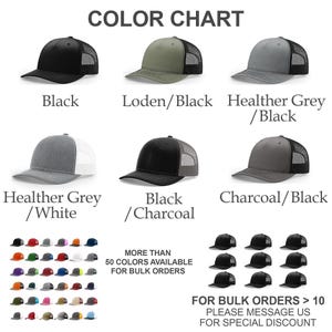 May include: Color chart of trucker hats in various colors, including black, heather grey, and charcoal. The hats have a mesh back and a curved brim. Text on the image says "MORE THAN 50 COLORS AVAILABLE FOR BULK ORDERS" and "FOR BULK ORDERS > 10 PLEASE MESSAGE US FOR SPECIAL DISCOUNT."