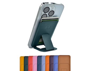 May include: A teal leather phone stand with a built-in card holder. The stand is attached to a silver iPhone with a camera lens. The stand is shown in a variety of colours, including brown, orange, red, pink, blue, and green.