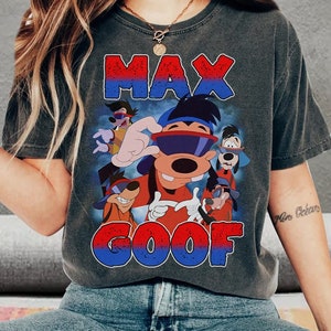 May include: A gray t-shirt with a vintage-style graphic of Max Goof from the Disney cartoon A Goofy Movie. The graphic features Max Goof wearing sunglasses and a backwards hat, with other characters from the movie in the background. The text "Max Goof" is printed in red and blue.