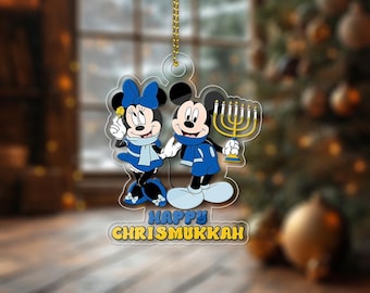 May include: Clear acrylic ornament featuring Mickey and Minnie Mouse in blue outfits, holding a menorah and a flower. The ornament has the text "HAPPY CHRIS MUKKAH" in yellow and blue.