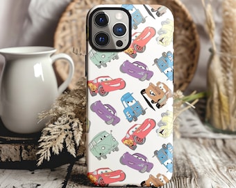 May include: A white phone case with a colorful cartoon pattern of cars. The case features a variety of cars in different colors, including red, blue, green, and purple. The cars are all cartoonish and have smiling faces. The case is designed for a phone with a camera bump.