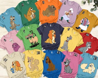May include: A set of 15 t-shirts featuring various Disney characters, including Lady and the Tramp, 101 Dalmatians, and The Fox and the Hound. The shirts are in various colors, including yellow, blue, pink, green, and red. Each shirt has a different character design.
