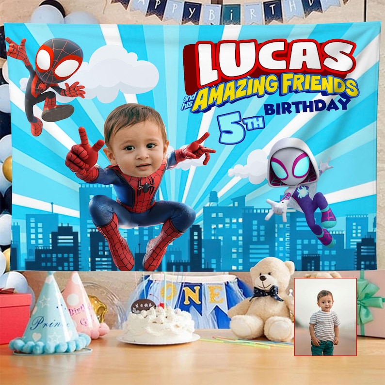 May include: A blue birthday backdrop with the text "LUCAS and his AMAZING FRIENDS 5th BIRTHDAY". The backdrop features illustrations of Spider-Man characters and a child dressed as Spider-Man. Party hats, a cake, and a teddy bear are also visible.