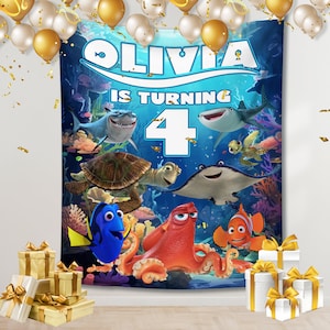 May include: A blue and white backdrop with a Finding Nemo theme. The backdrop features the characters Dory, Marlin, and Hank the octopus. The text "Olivia is turning 4" is printed on the backdrop.