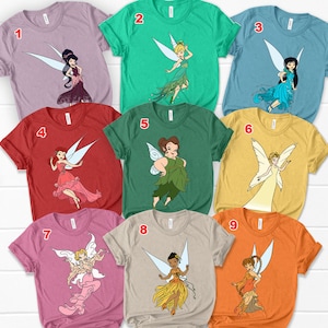 May include: Nine different t-shirts featuring various Disney fairies. Each shirt has a different fairy character and a number from 1 to 9 printed on the front.